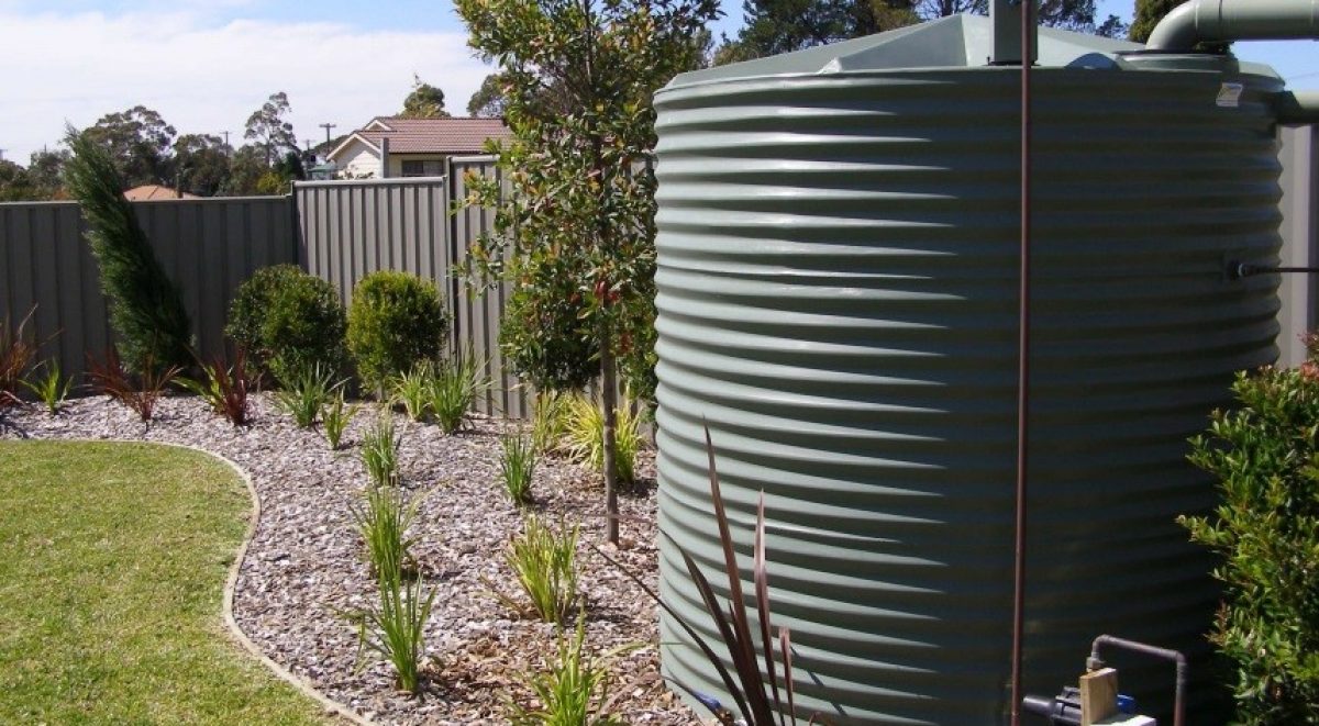 Rainwater tank in a backyard garden