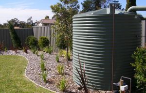 Rainwater tank in a backyard garden